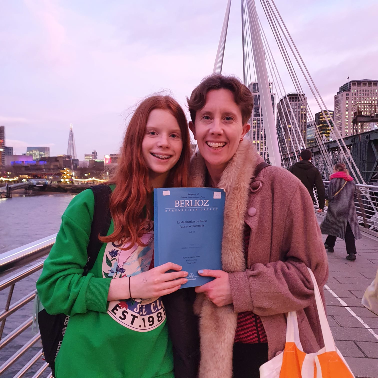 LYC member and their parent standing side by side, holding one score of Berlioz's 'The Damnation of Faust'